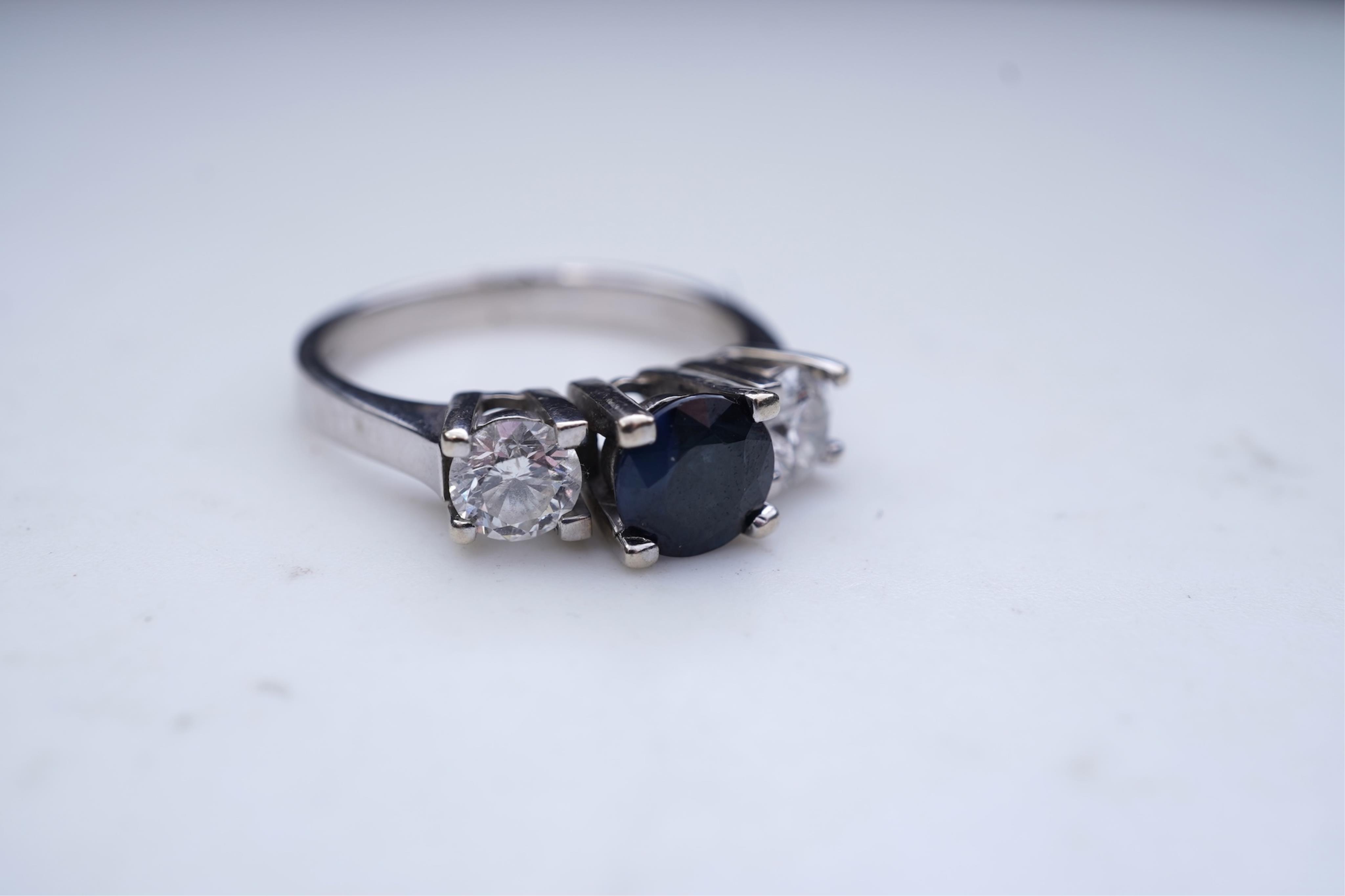 A sapphire and diamond three-stone ring